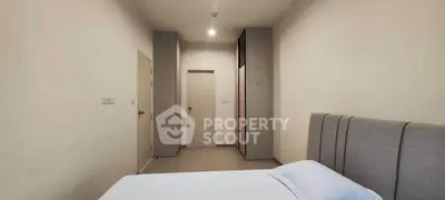 Spacious bedroom with modern design and ample storage in a stylish apartment.