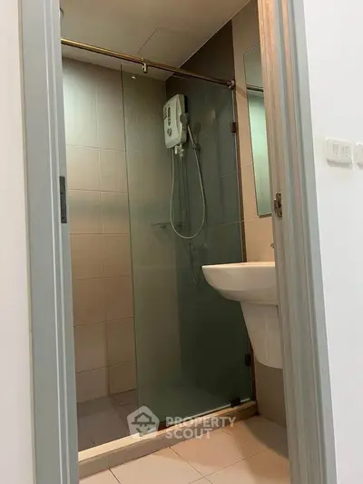 Modern bathroom with glass shower enclosure and sleek fixtures