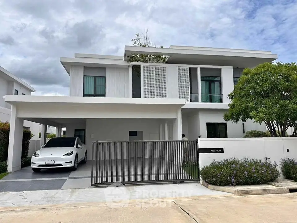 Modern two-story house with sleek design and electric car in driveway