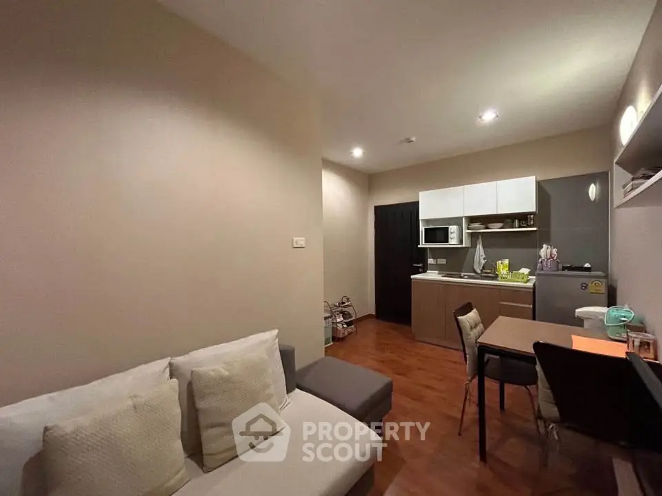 Cozy living room with open kitchen layout in modern apartment