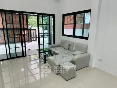 Modern living room with sleek furniture and large windows