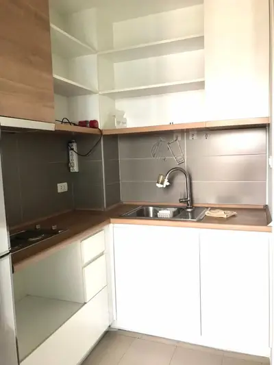 Modern compact kitchen with sleek cabinetry and stainless steel sink