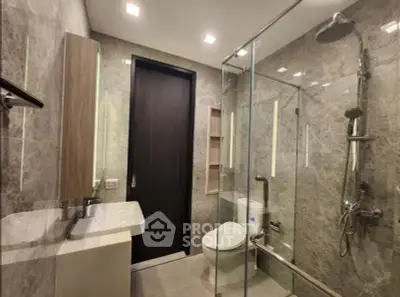 Luxurious modern bathroom with glass shower and elegant fixtures
