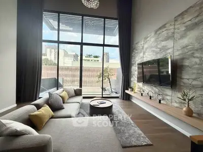 Luxurious living room with floor-to-ceiling windows and modern decor