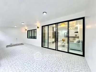 Spacious modern interior with large glass doors and elegant lighting