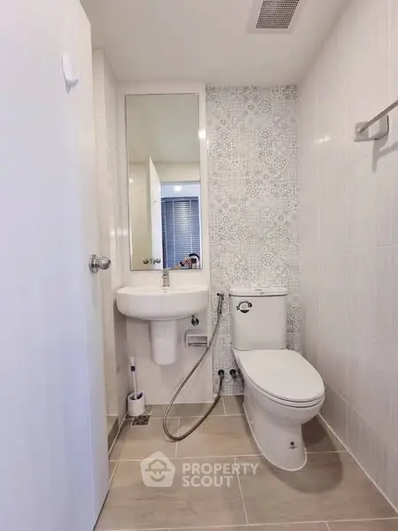 Modern bathroom with elegant tile design and sleek fixtures in a contemporary apartment.