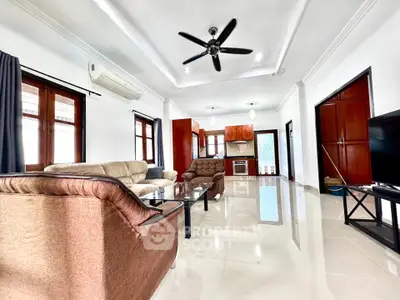Spacious living room with modern furniture and ceiling fan in a bright open layout