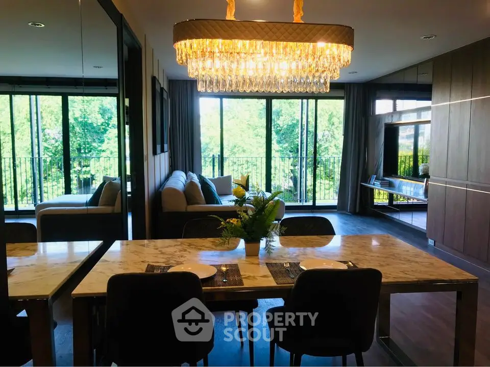 Luxurious living room with elegant chandelier and panoramic garden view