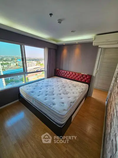 Spacious bedroom with city view and elegant decor in modern apartment