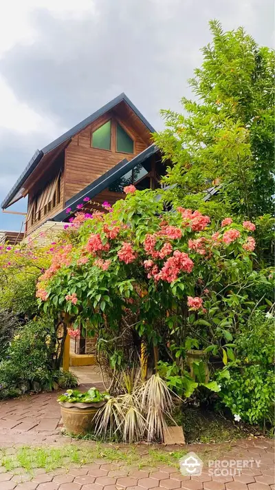 Charming wooden house with lush garden and vibrant flowers, perfect for nature lovers seeking tranquility.