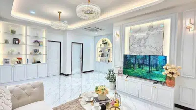 Luxurious living room with elegant decor, marble accents, and modern lighting, perfect for sophisticated living.
