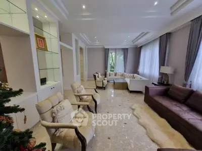 Spacious and elegant living room with modern decor and ample seating.