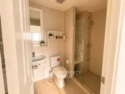 Modern bathroom with glass shower and sleek fixtures in a contemporary home.