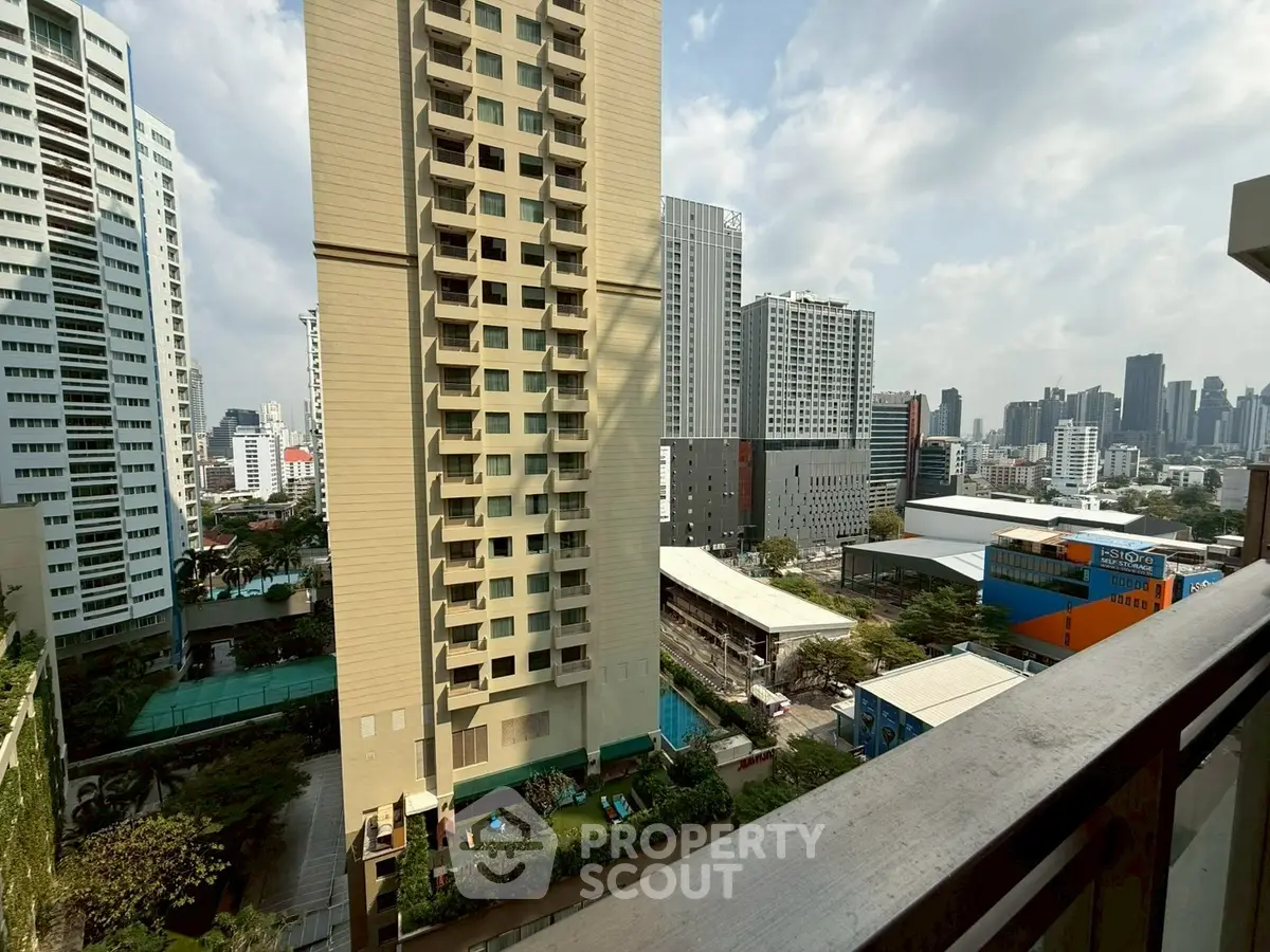 Stunning cityscape view from a high-rise balcony in urban setting.
