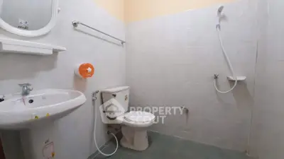 Spacious bathroom with modern fixtures and open shower design, ideal for comfort and convenience.