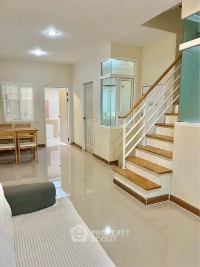 Spacious modern living room with staircase and dining area in elegant home