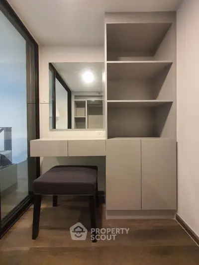 Modern study nook with built-in shelves and desk in a stylish apartment.