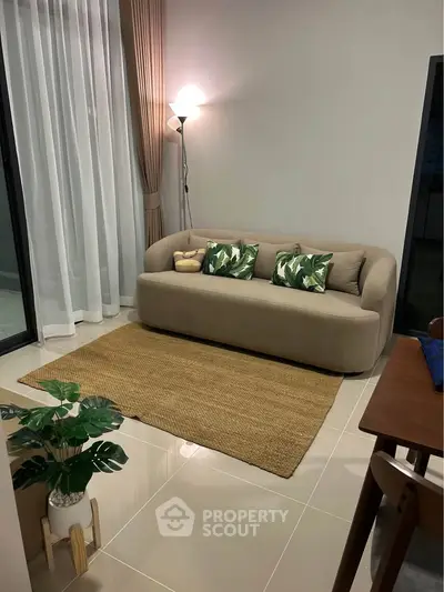 Cozy living room with modern sofa, stylish decor, and warm lighting for a welcoming ambiance.