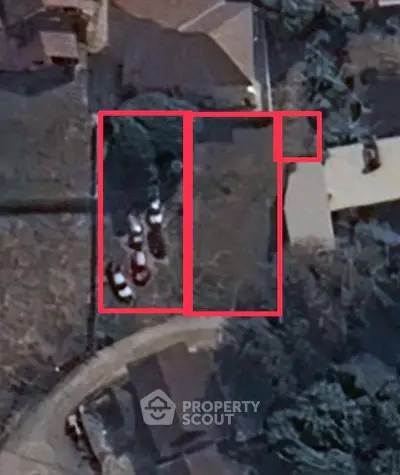 Aerial view of residential property with outlined boundaries and parked cars.