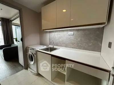 Modern kitchen with sleek cabinetry and built-in washing machine