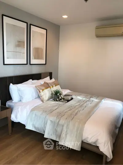Elegant bedroom with modern decor and cozy bedding in a stylish apartment.