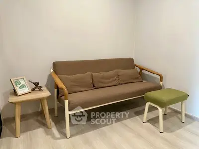 Cozy minimalist living room with modern sofa and wooden side table.