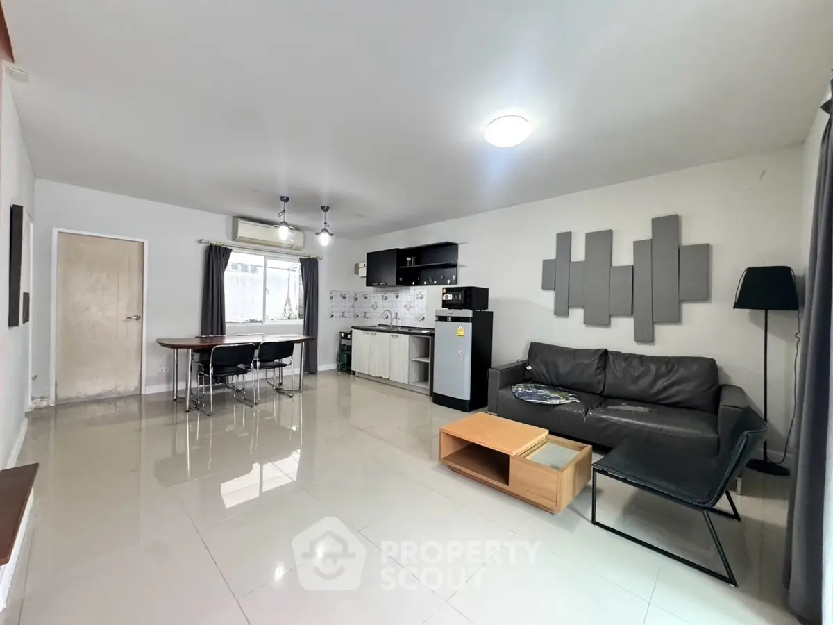 Spacious modern living room with open kitchen and stylish decor
