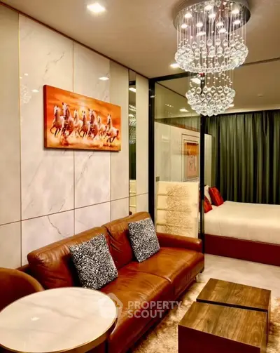 Luxurious living room with elegant decor and modern chandelier in upscale apartment.