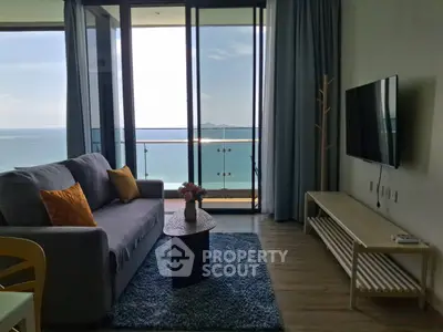 Stunning living room with ocean view and modern decor in beachfront apartment.