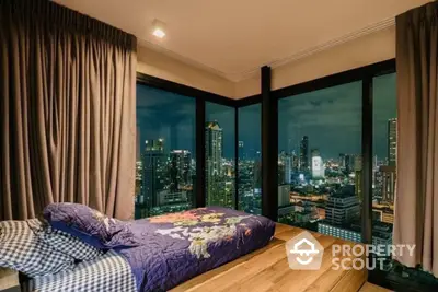 Luxurious bedroom with stunning city skyline view at night