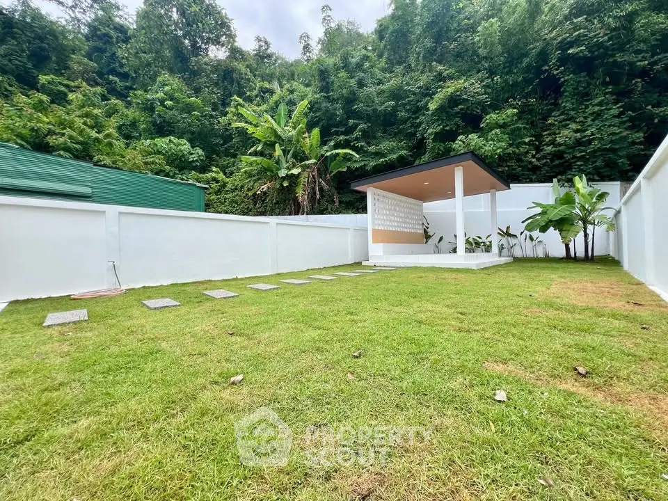 Spacious garden with modern gazebo and lush greenery