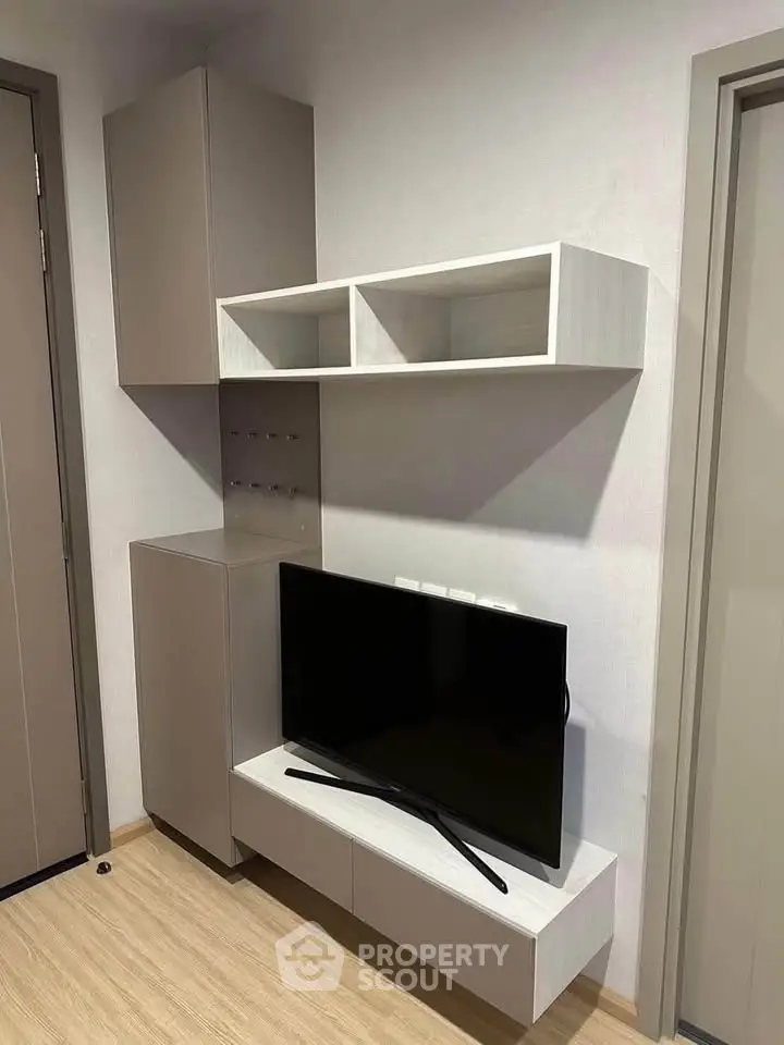 Modern living room with sleek TV unit and minimalist shelving