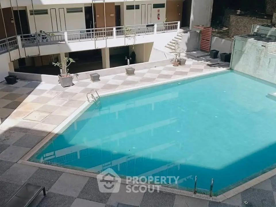 Spacious residential pool area with modern design and ample sunlight, perfect for relaxation and leisure.