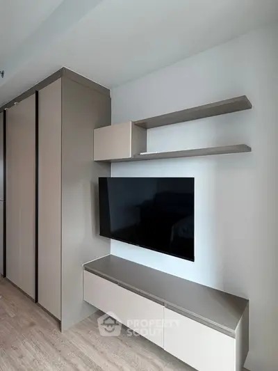 Modern living room with sleek TV unit and storage shelves