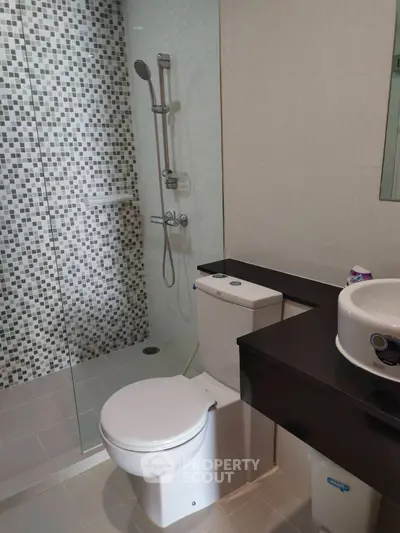 Modern bathroom with glass shower and sleek fixtures