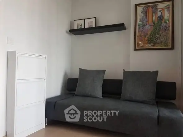 Cozy living room with modern gray sofa and elegant wall art