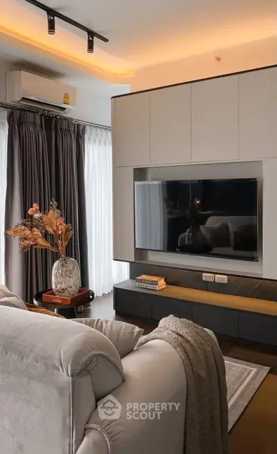 Modern living room with sleek TV setup and cozy seating area