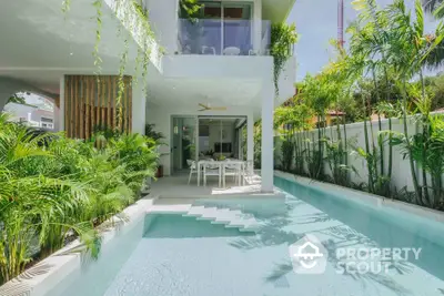 Luxurious modern villa with private pool and lush greenery, perfect for tropical living.