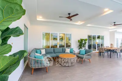 Spacious modern living room with stylish furniture and large windows opening to a garden view.