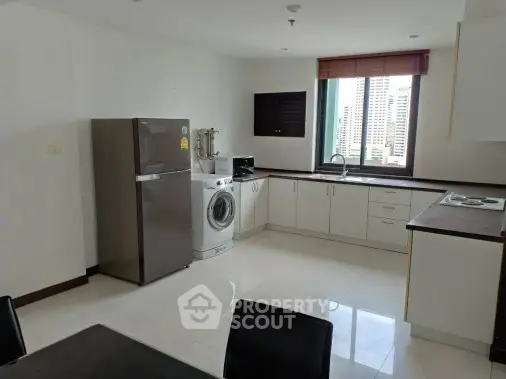 Spacious kitchen with modern appliances and city view window