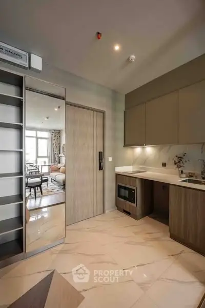Modern kitchen with sleek cabinetry and built-in appliances in a stylish apartment.