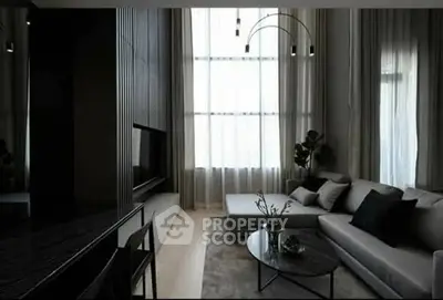 Modern living room with sleek furniture and large windows