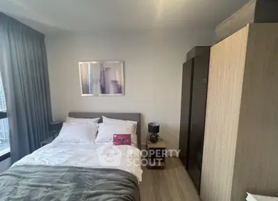 Cozy bedroom with modern decor and ample natural light