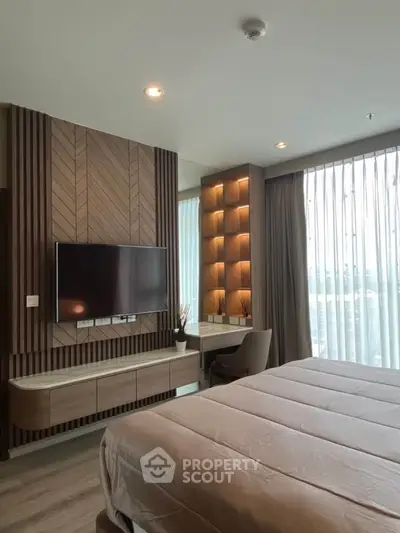 Luxurious bedroom with modern decor, large window, and built-in TV unit.