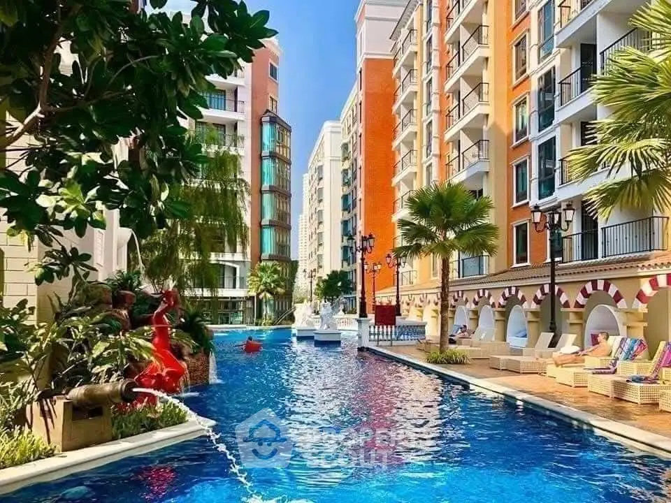 Luxurious residential complex with stunning pool and vibrant architecture.