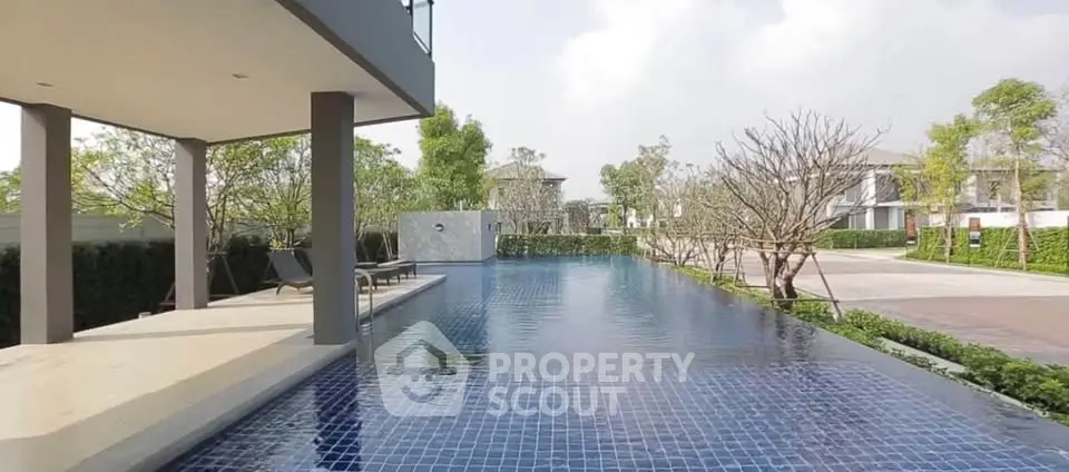 Luxurious outdoor pool area with modern design and lush greenery