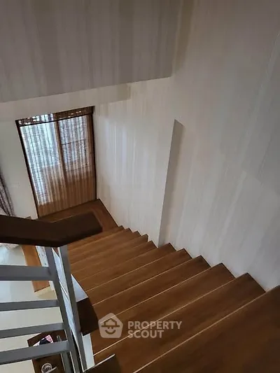 Elegant wooden staircase with modern design and natural light