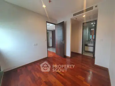 Spacious and inviting empty living space with polished hardwood floors and ample natural light, ready for personalization.