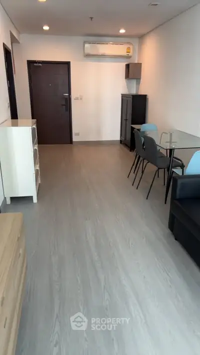 Modern living room with sleek furniture and wooden flooring in a contemporary apartment.