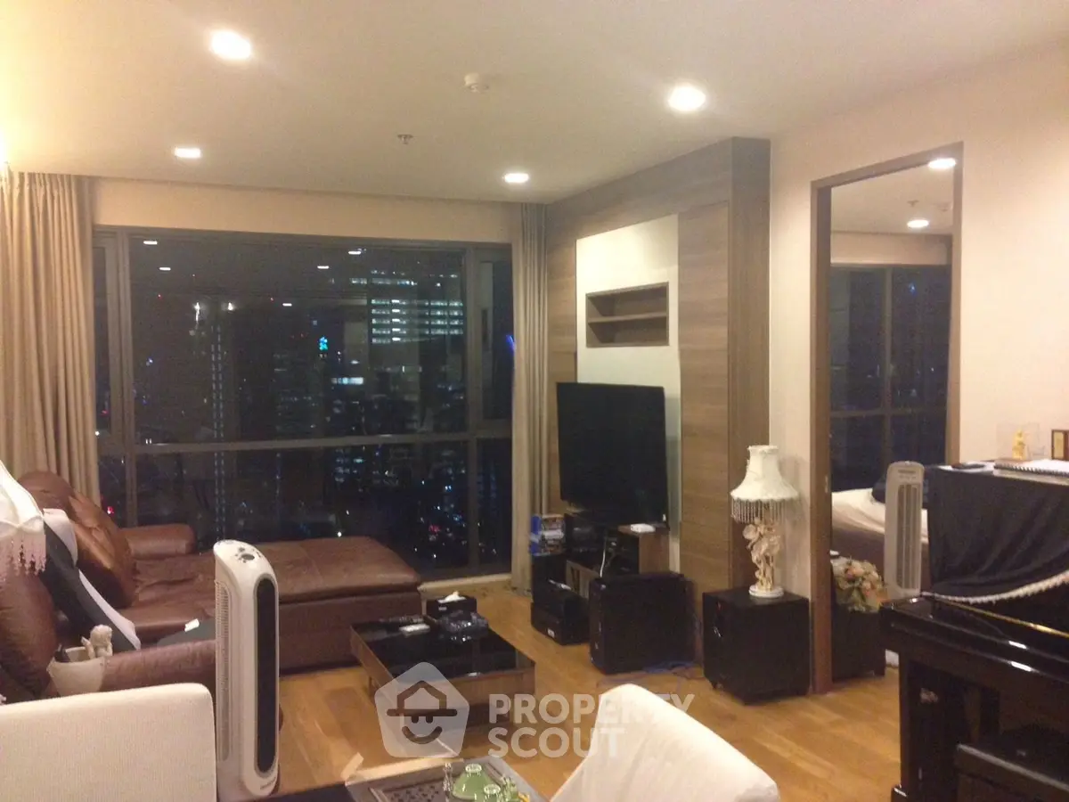 Luxurious high-rise living room with stunning city view, modern furnishings, and ambient lighting.